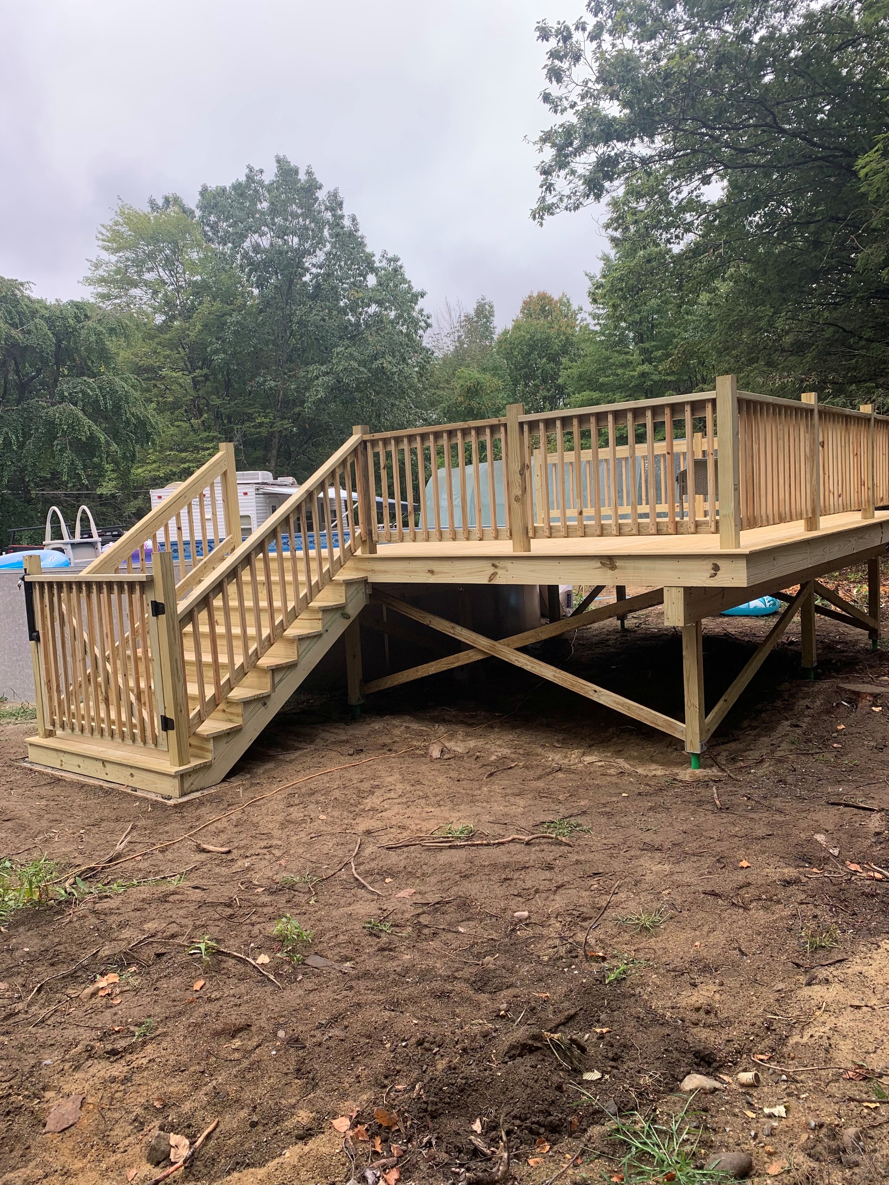 Elevated pool deck with wood railings and stairs