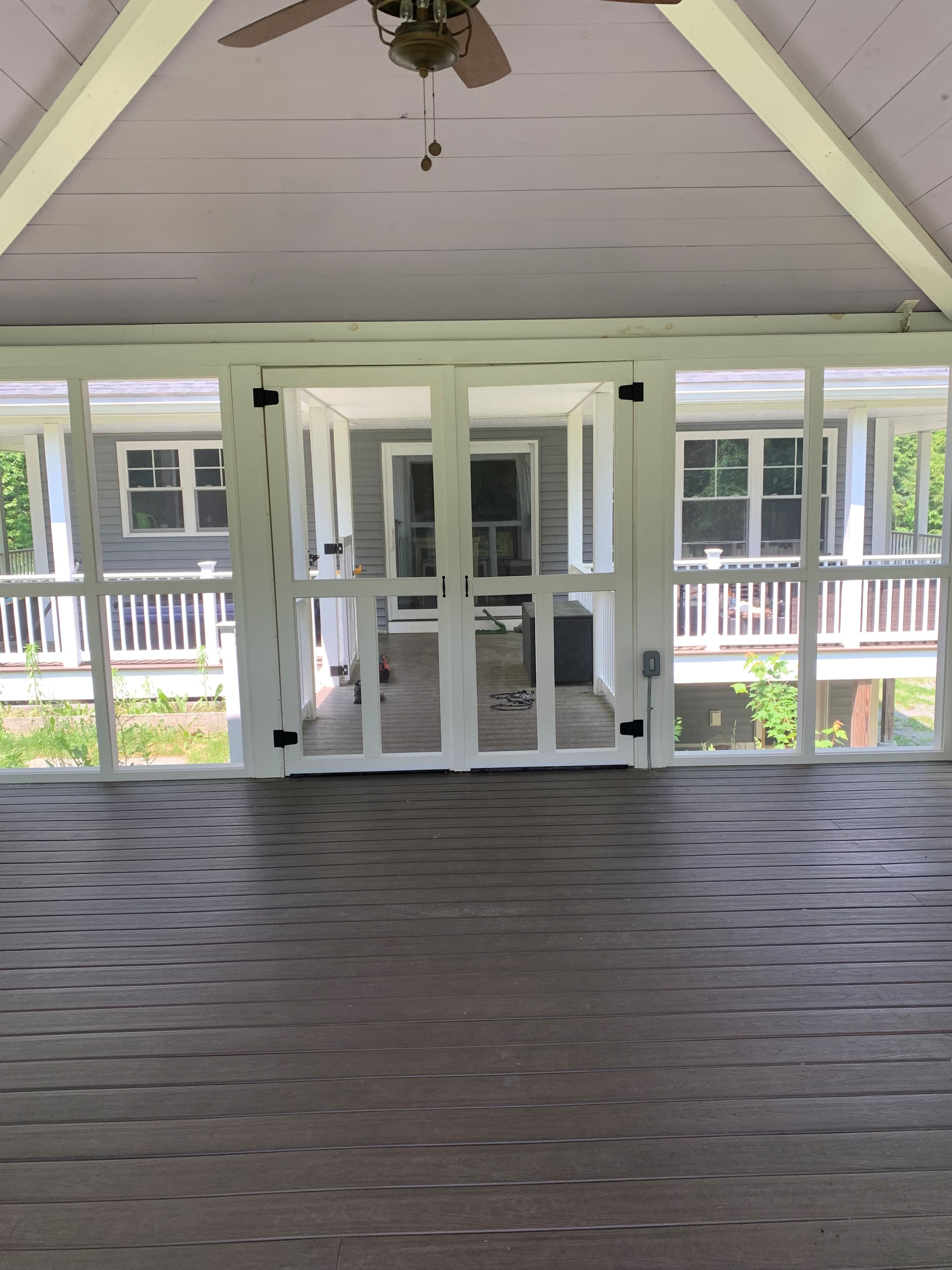 Screened porch interior with vaulted ceiling and French doors